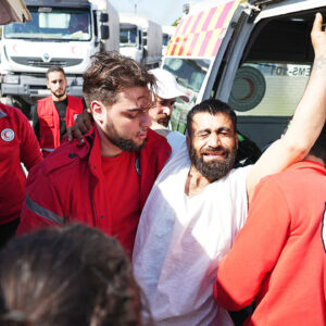 Syrian Red Crescent members transport injured civilians from the Kmeimim base, Latakia, Syria