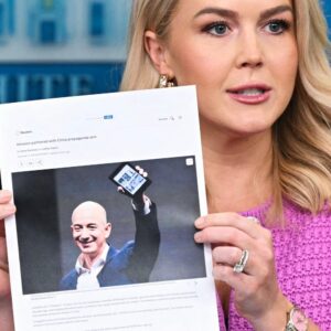 White House press secretary Karoline Leavitt holds up a printed article from 2021 about Amazon's Jeff Bezos during a briefing at the White House on April 29, 2025.
