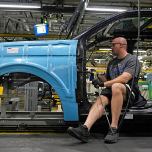 A vehicle assembly technician works on a 2025 Ford Expedition