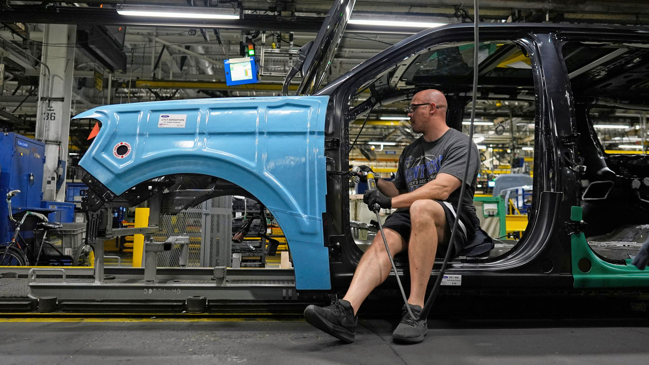 A vehicle assembly technician works on a 2025 Ford Expedition