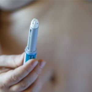 Wanita memegang pena semaglutide oempic